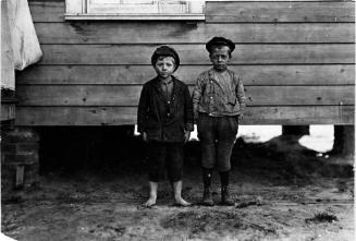 In neighborhood of Maple Mill, Dillon, S.C. Lawrence Faircloth (taller boy) "Don't know how old I am." Been in mill 2 years. Runs 3 sides Albert Bartlett (barefoot) Looked 8 years old. In mill 2 years--Beginning to spin. Runs 2-1/2 sides = 25 cents a day.