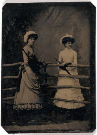 Portrait of Two Women by a Fence