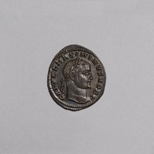 Follis: Laureate Head of Maximinus II Right; Genius Nude/Draped on Shoulders Standing Left, Puring Libation and Holding Cornucopiae on Reverse
