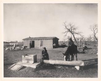 Quenching His Thirst.  A Sod House