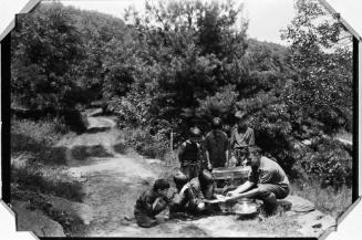 Man with Boys Looking at Mice