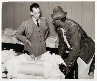 Tenant farmer brings his cotton sample to buyer/broker to discuss price. Clarksdale, Mississippi