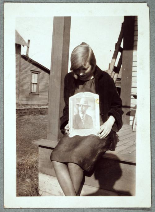 Girl with Portrait Sitting on Porch