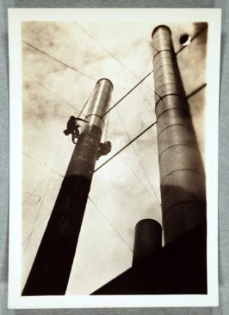 Smoke Stacks, with Men Climbing