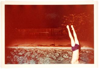 Man Diving in Water at Night