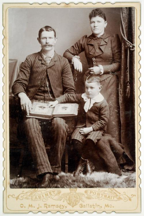 Portrait of a Family with an Album