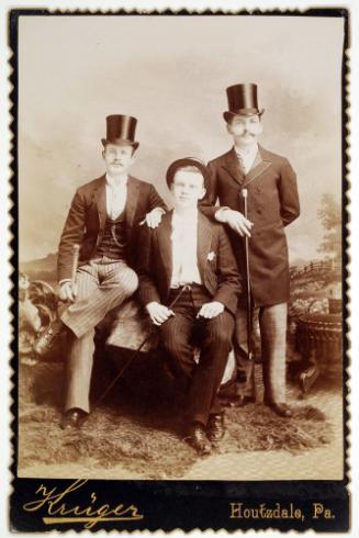 A Group of Three Men Facing a Camera